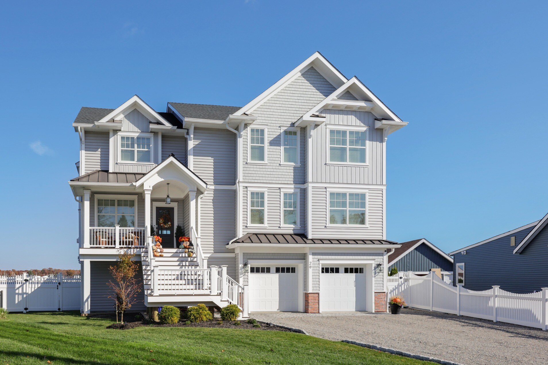 Custom-built home by GTG Builders in Brick, NJ, featuring multiple floors, large windows, and a well-manicured lawn.