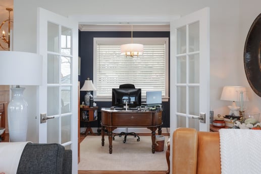 Home office space in a custom home by GTG Builders in Brick, NJ, with French doors, a classic wood desk, and decorative accents