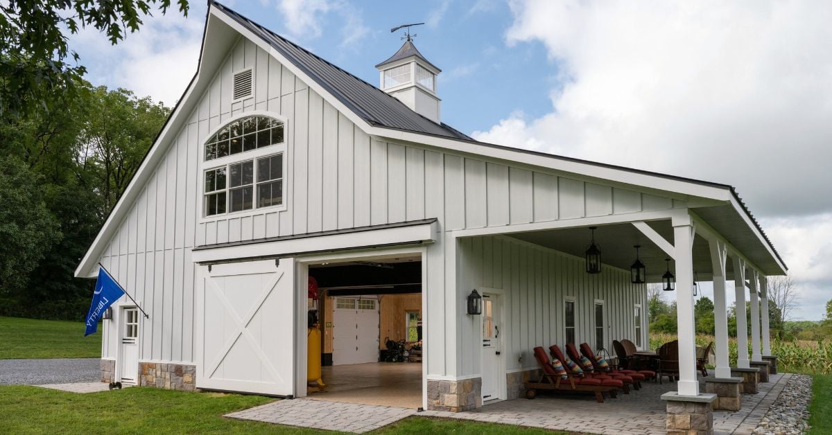 white barn carriage home with large porch and extra seating by GTG Builders in New Jersey