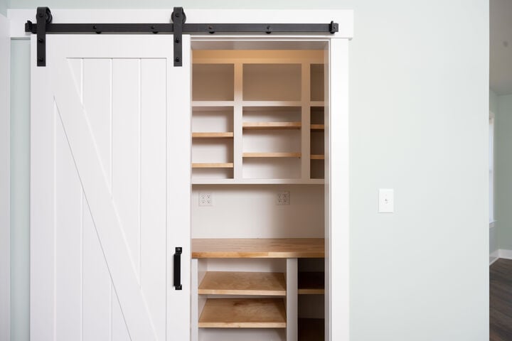 white sliding door leading into closet in custom home by GTG Builders in Central New Jersey