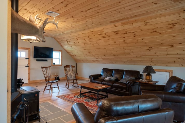 interior of custom home with wood ceiling and deer head in central new jersey by GTG Builders