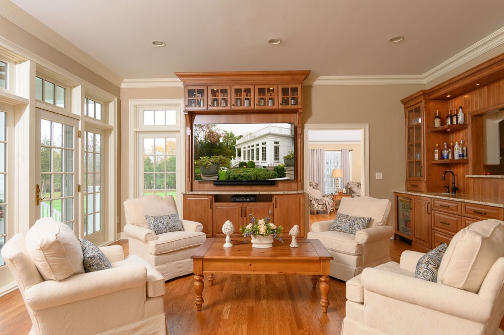 custom living room with brown cabinets and white furniture by gtg builders in new jersey