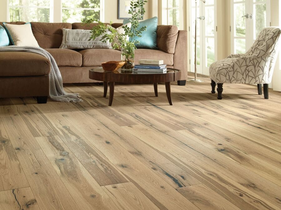 light oak flooring with brown couch and white chair - photo by Shaw Floors