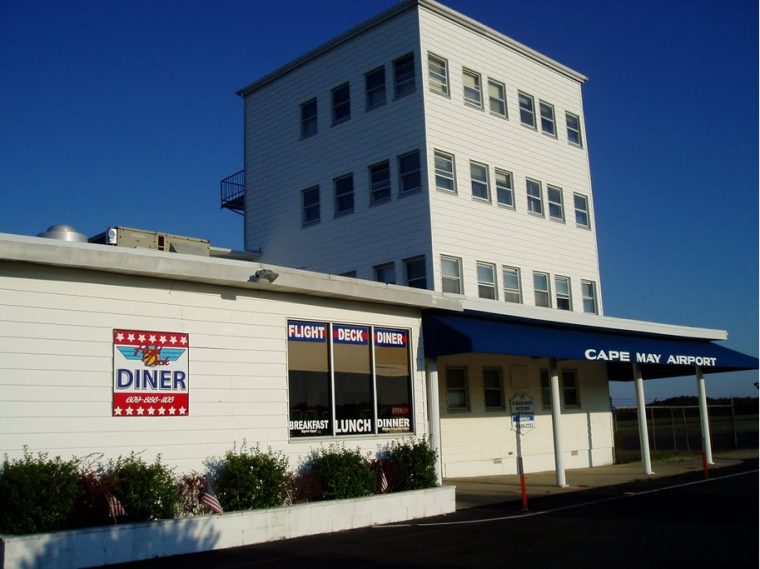 white building of flight deck diner exterior with clear blue skies in cape may airport
