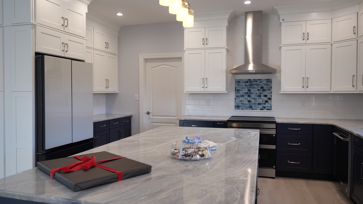 Elegant kitchen design with navy base cabinets and sleek appliances in a net-zero custom home in Bloomsbury, NJ by GTG Builders