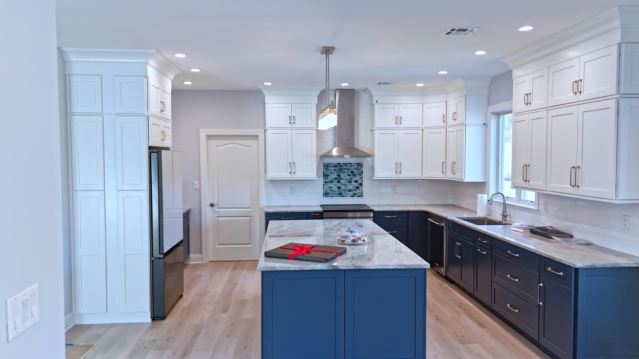 Functional and stylish kitchen with stainless hood and modern lighting in a net-zero custom home in Bloomsbury, NJ by GTG Builders