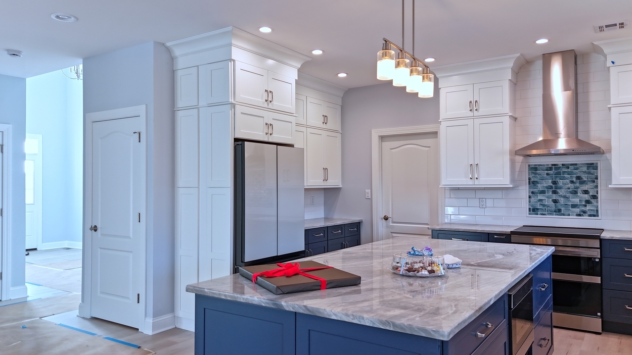 Luxury kitchen interior with center island and stainless range hood in a net-zero custom home in Bloomsbury, NJ by GTG Builders