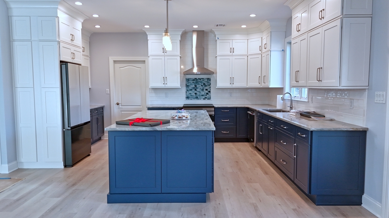 Open kitchen with modern appliances and subway tile walls in a net-zero custom home in Bloomsbury, NJ by GTG Builders