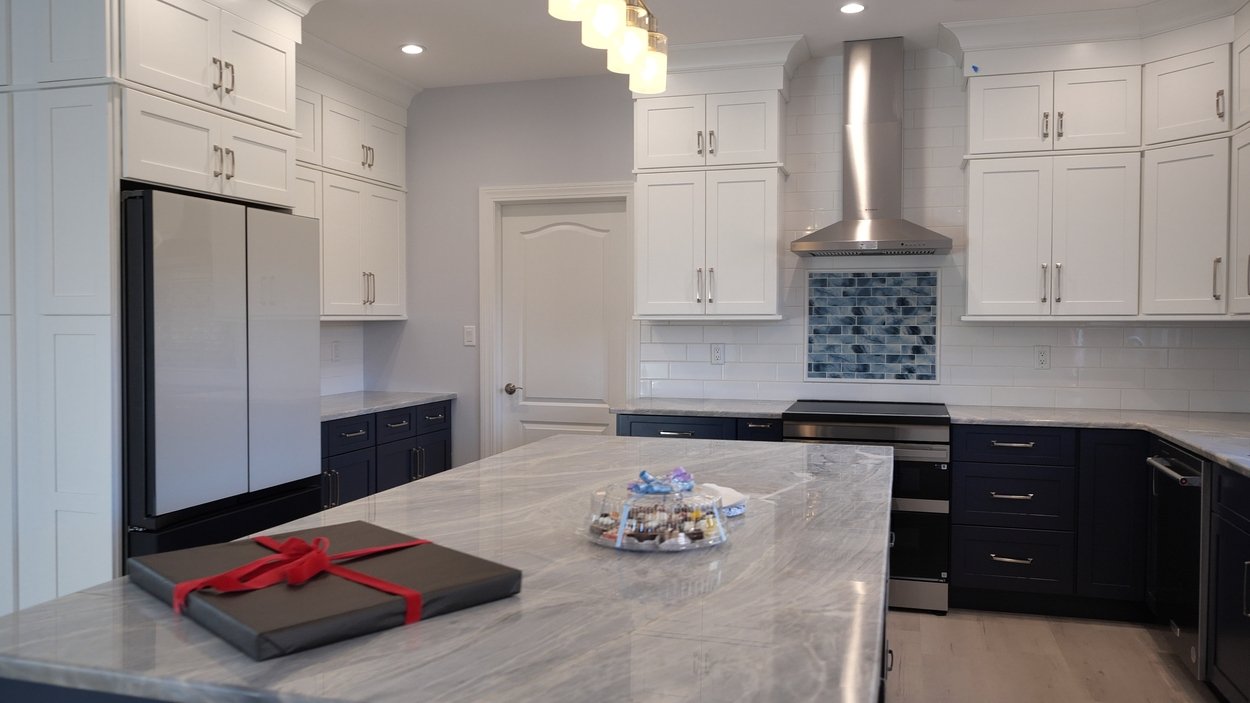 Elegant kitchen design with navy base cabinets and sleek appliances in a net-zero custom home in Bloomsbury, NJ by GTG Builders