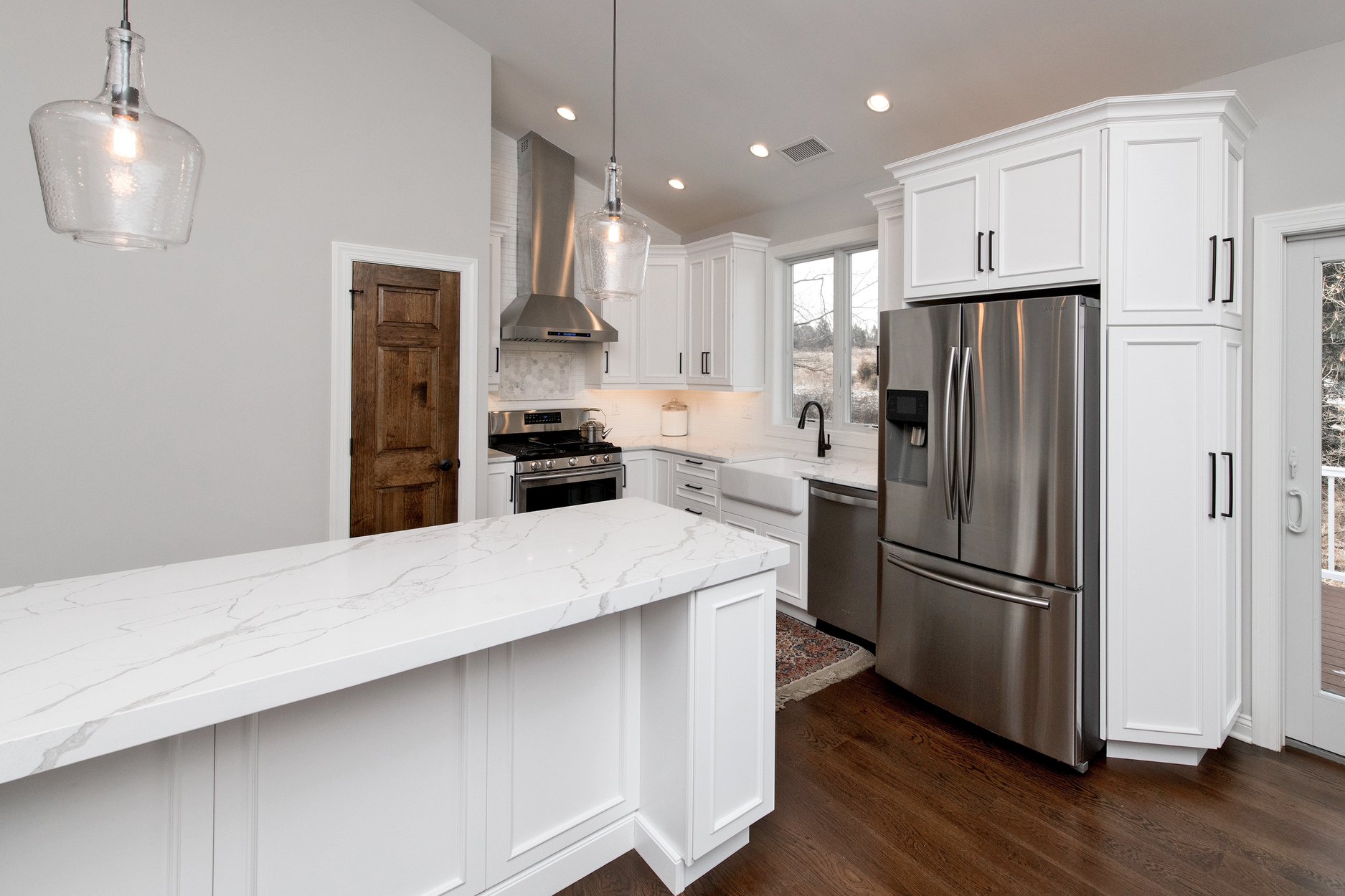 white kitchen woth marble island in guest suite by GTG builders in new jersey