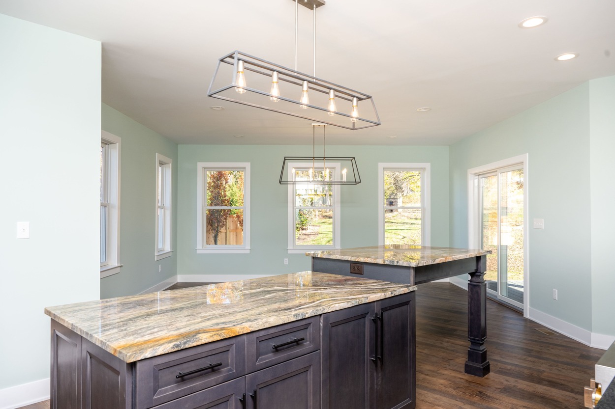 living space with two story island and angled walls in custom home by GTG Builders in Central New Jersey