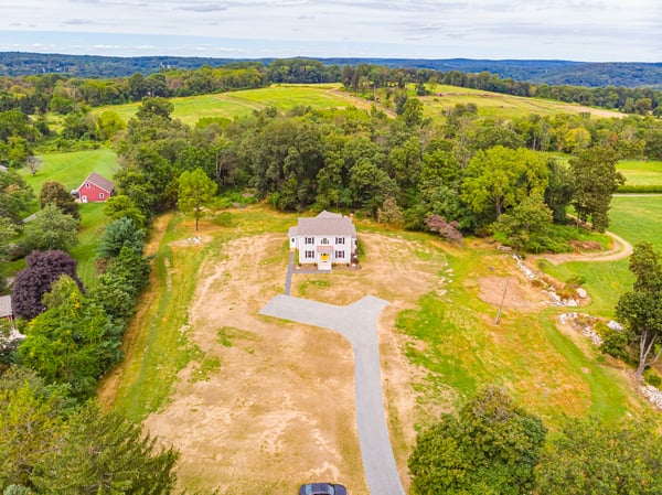 Aerial view of custom built home in Central, NJ with plenty of yard space and beautiful trees by GTG Builders