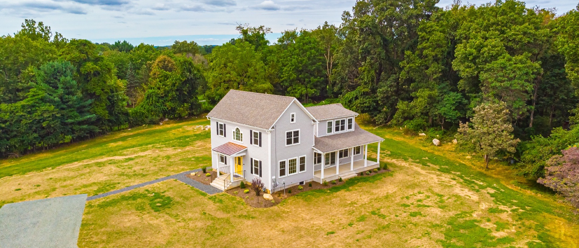 Aerial View of Custom Farmhouse with Yellow Door and Side Porch in Central New Jersey by GTG Builders