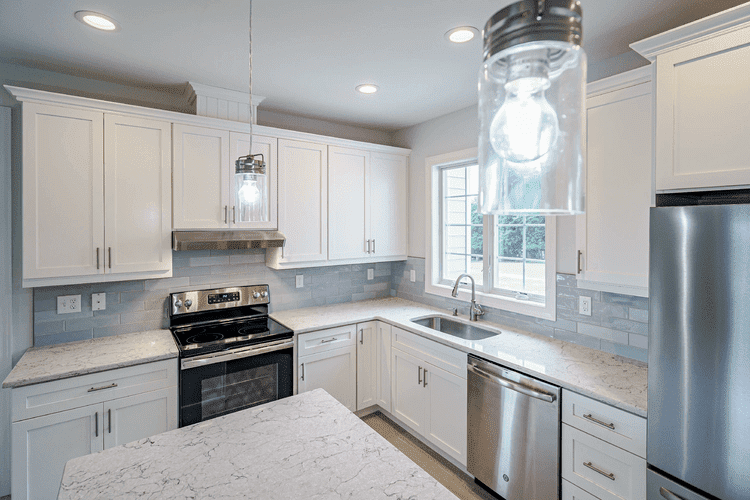 kitchen with white cabinets and counters in custom home by gtg builders in central new jersey