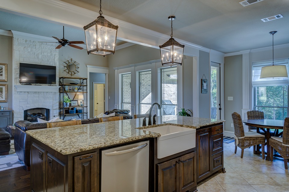 kitchen with granite island and 2 hanging light fixtures