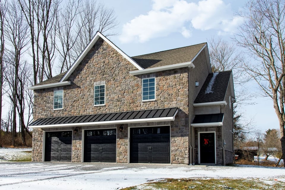 view of custom home in winter
