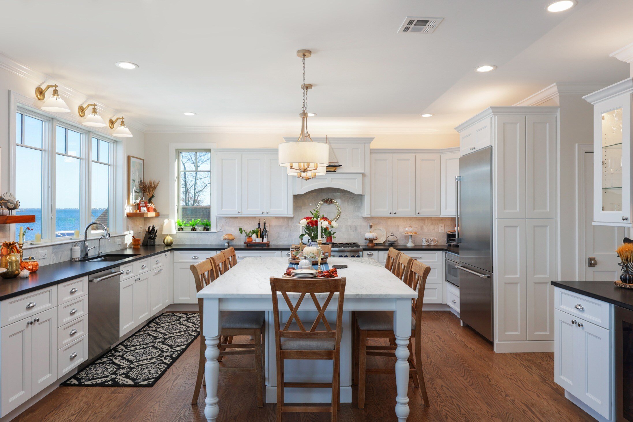 Spacious kitchen with a large center island, farmhouse-style lighting, and abundant natural light in a custom home by GTG Builders in Brick, NJ-1