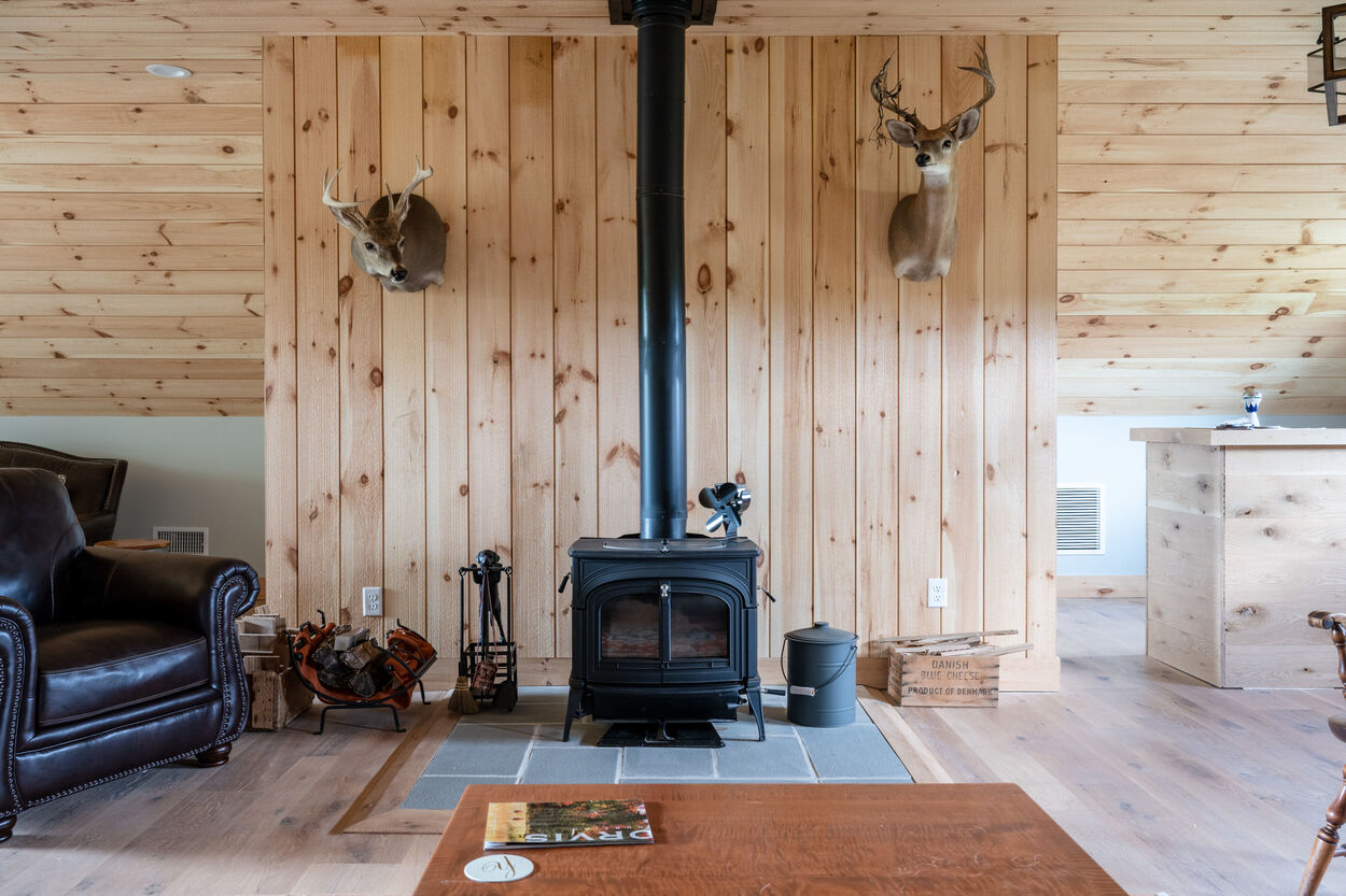 wood burning stove and wood wall by GTG Builders in Stockton, New Jersey