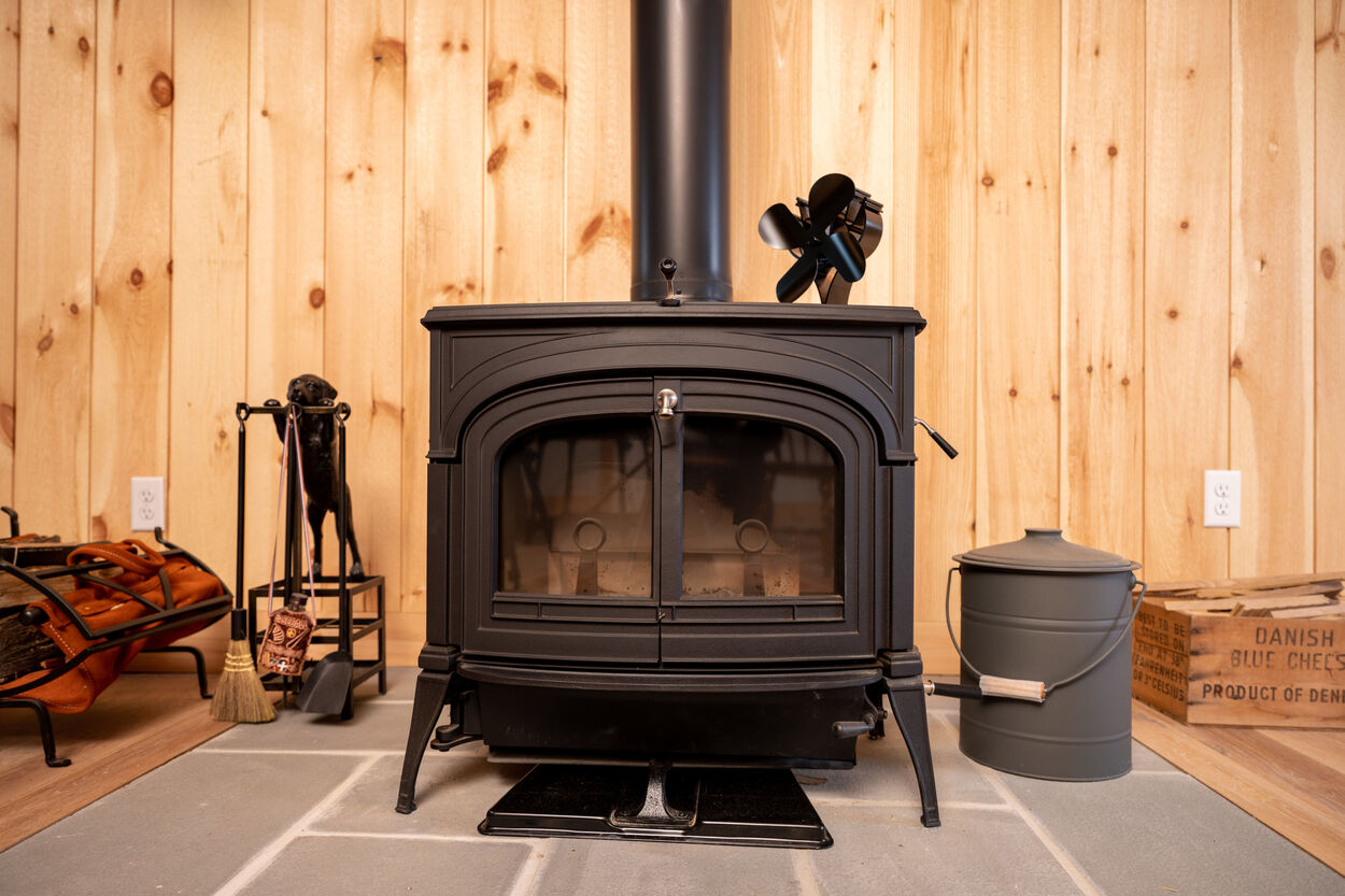 close up of black wood burning stove by GTG Builders in Stockton, New Jersey