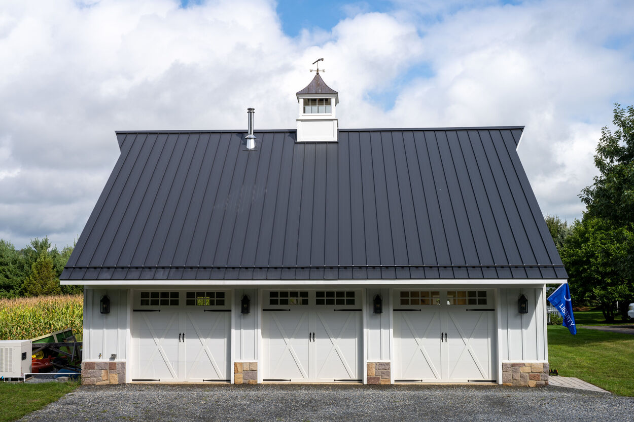 exterior shot of 3 white garage doors by GTG Builders in Stockton New Jersey