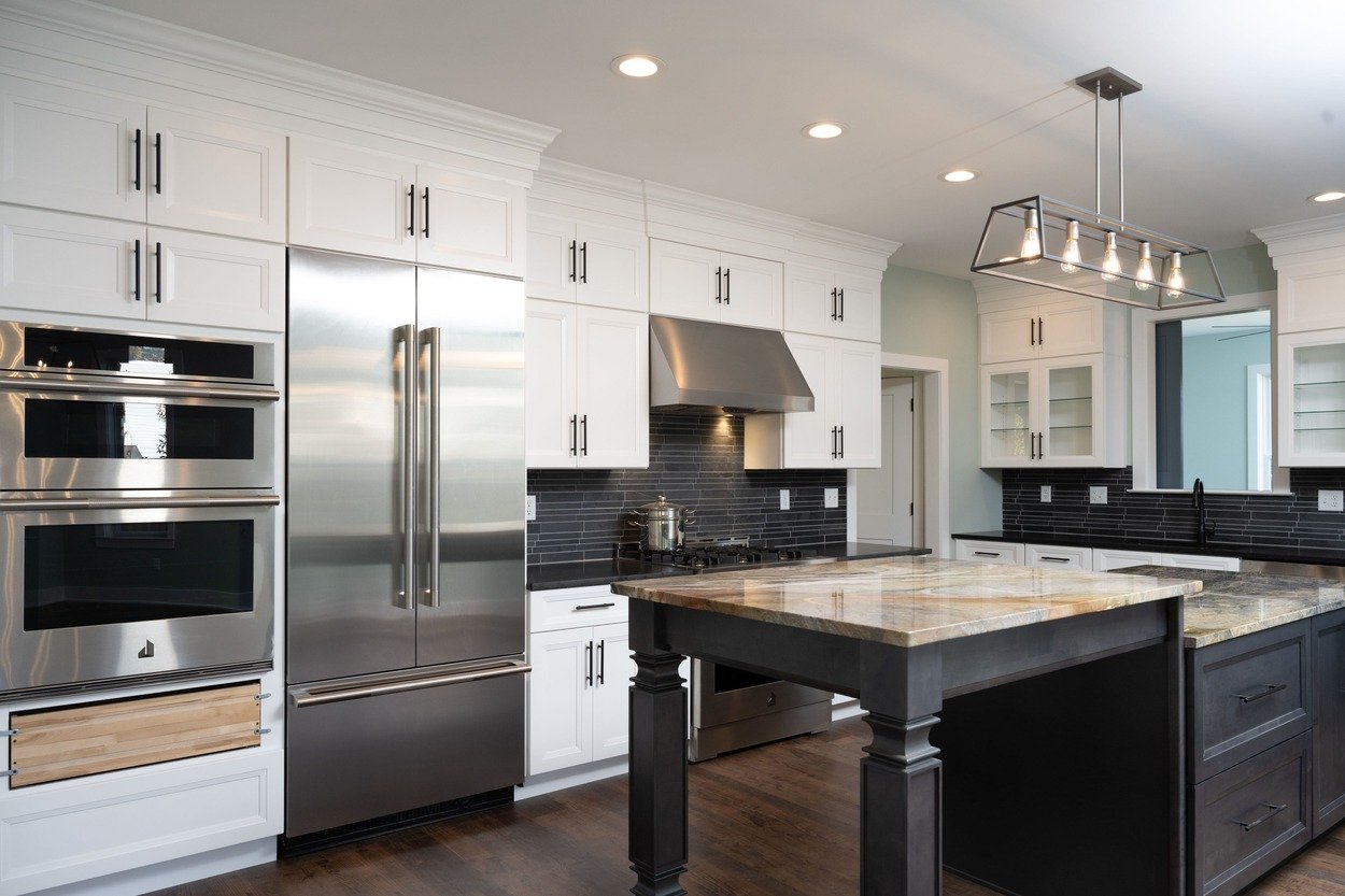 custom kitchen with fridge, oven, and two level island in custom home by GTG Builders in Central New Jersey