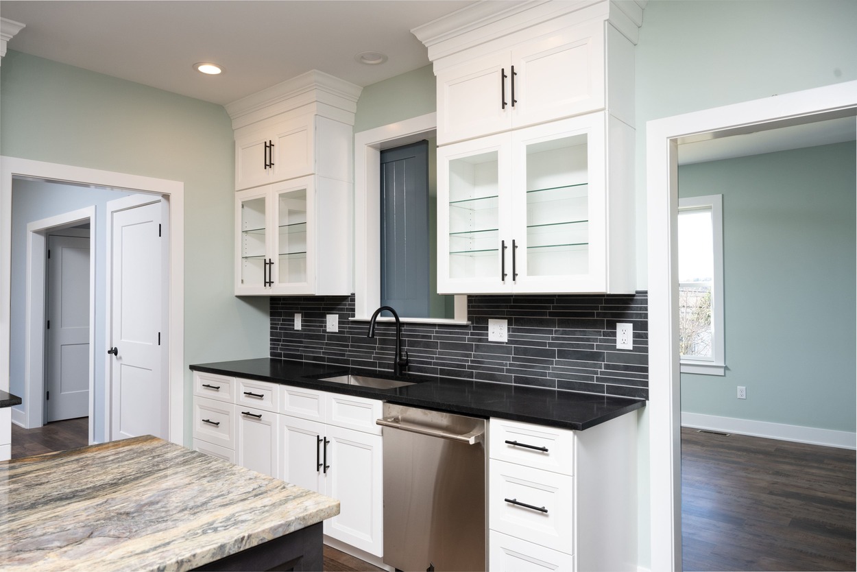 custom kitchen with dark counter and white cabinets in custom home by GTG Builders in Central New Jersey