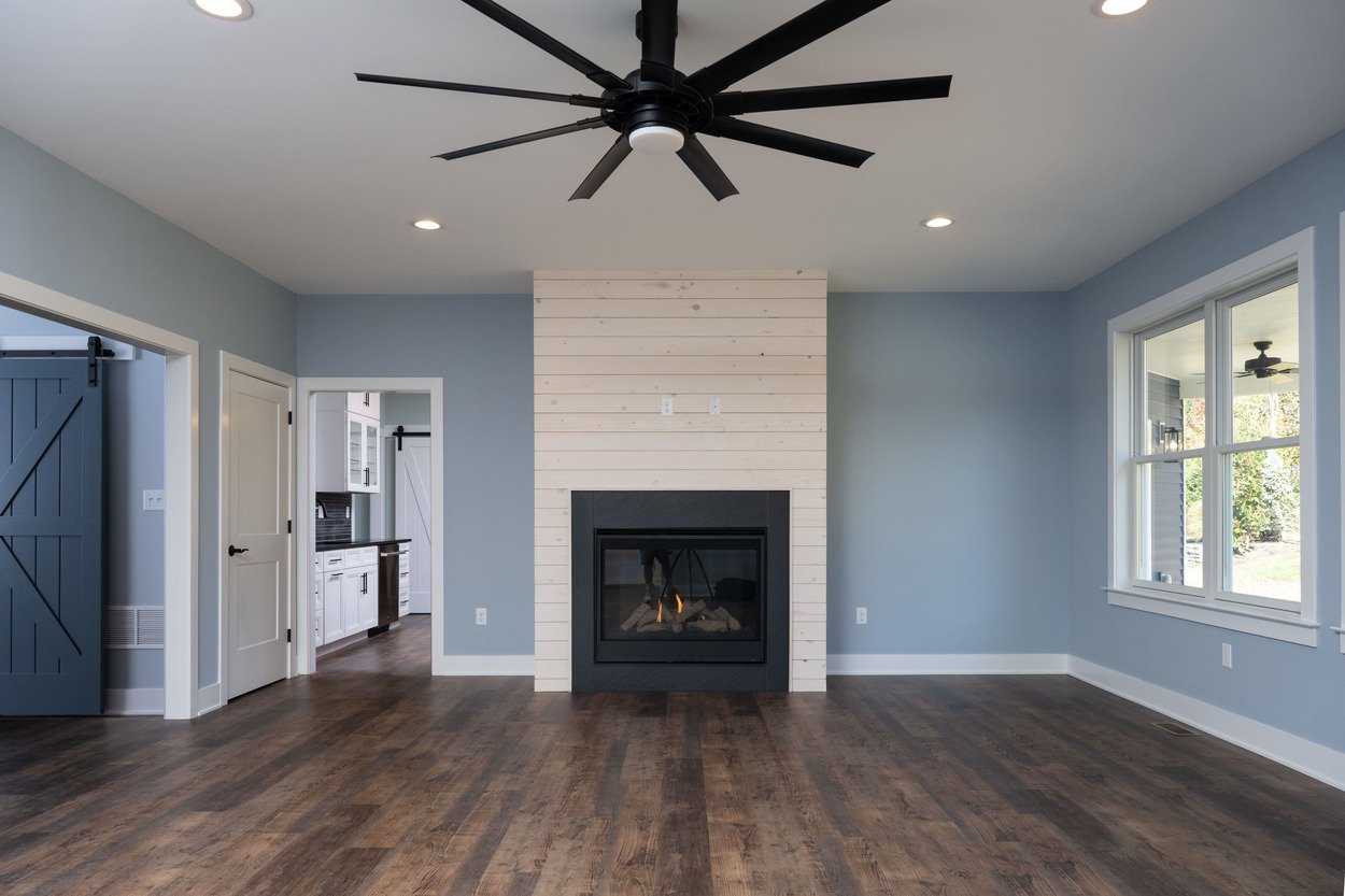 custom living room with fireplace in custom home by GTG Builders in Central New Jersey