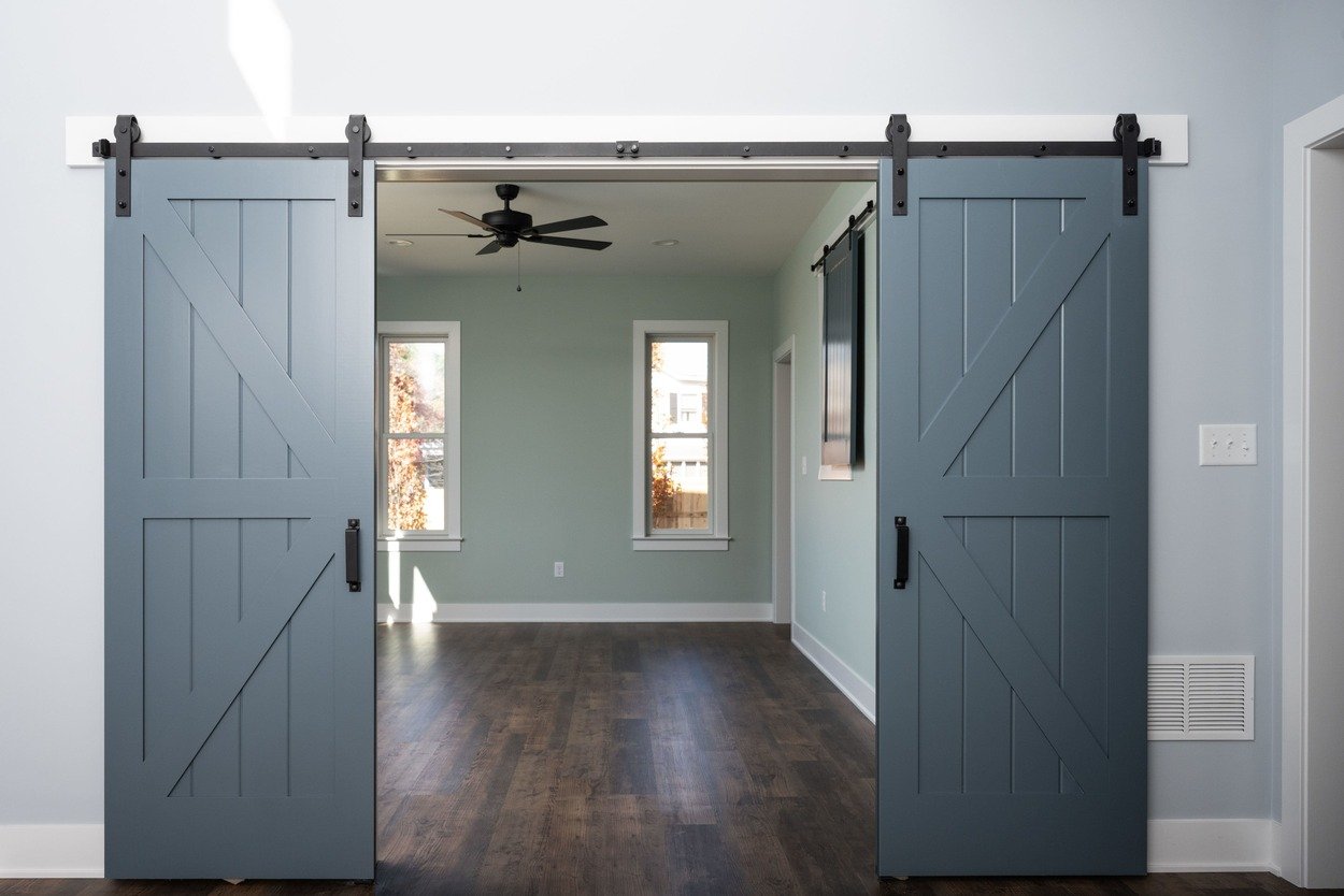 barn style doors leading into room in custom home by GTG Builders in Central New Jersey