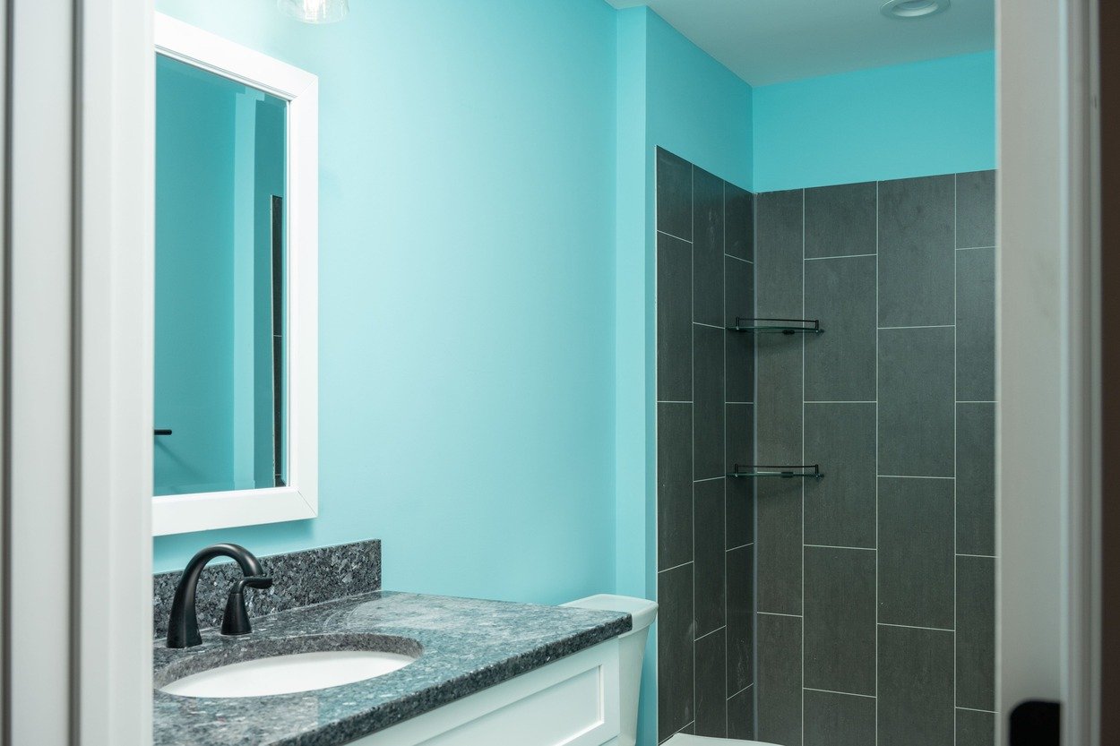 custom bathroom with blue walls and dark tiled shower in custom home by GTG Builders in Central New Jersey custom bathroom with blue walls and dark tiled shower in custom home by GTG Builders in Central New Jersey