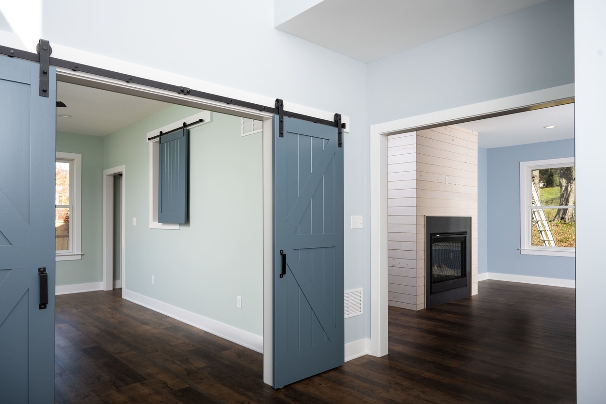 living space with barn style doors in custom home by GTG Builders in Central New Jersey