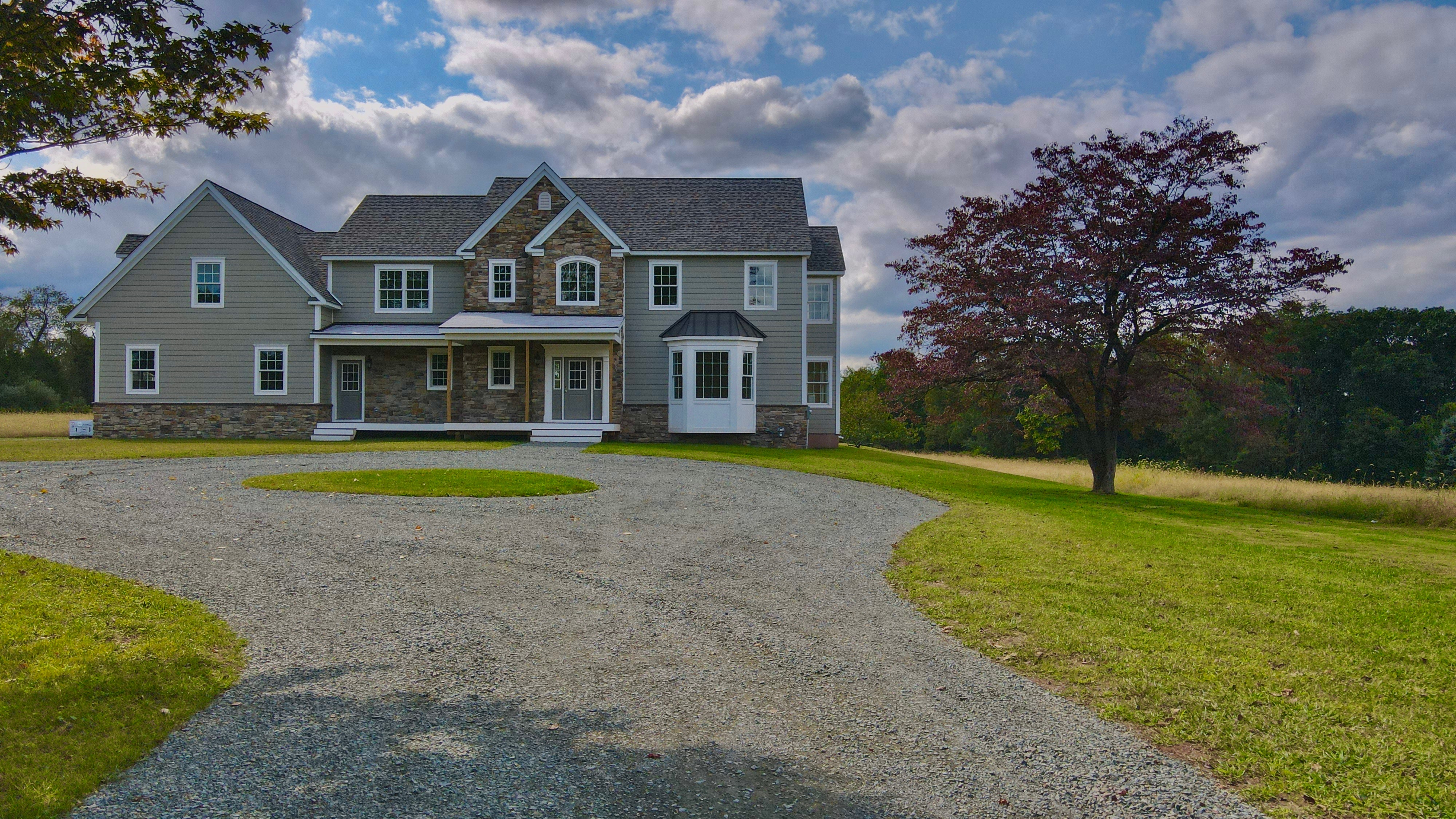 grey brick house built on bought land by GTG builders in new jersey