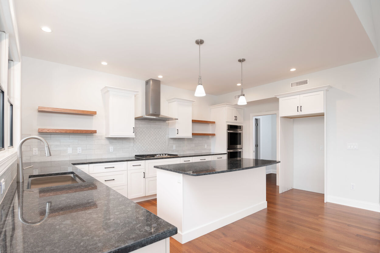 kitchen with black island and black countertops by gtg builders in central new jersey