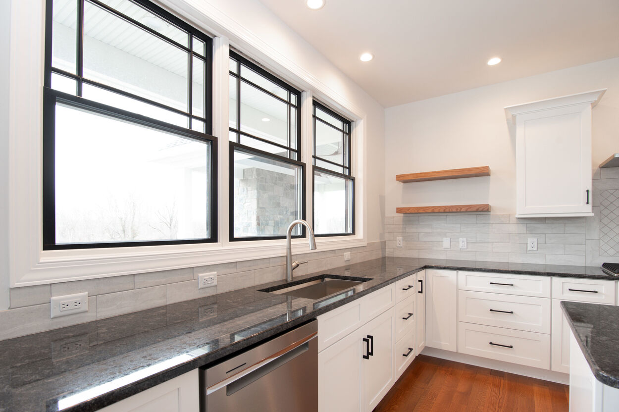 kitchen with black island and black countertops by gtg builders in central new jersey