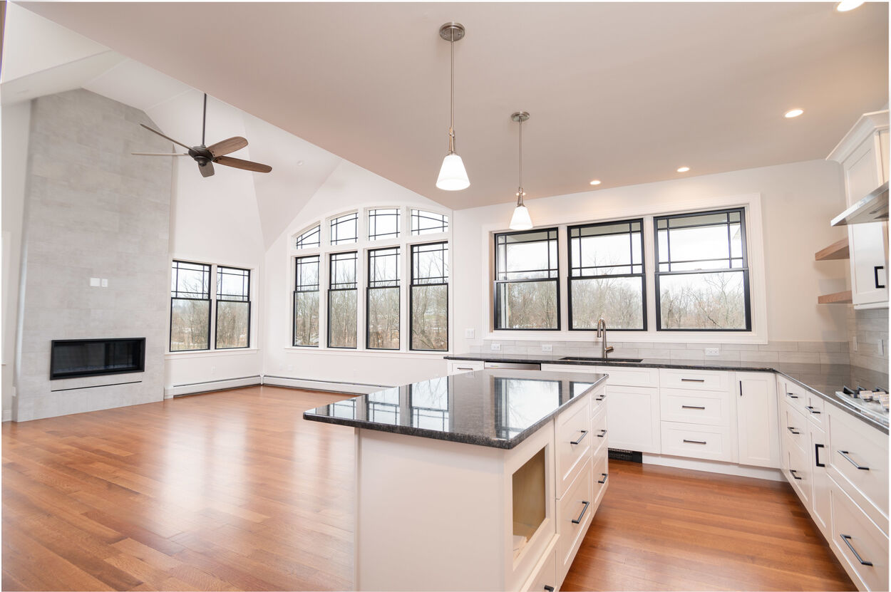 kitchen with black island and black countertops by gtg builders in central new jersey