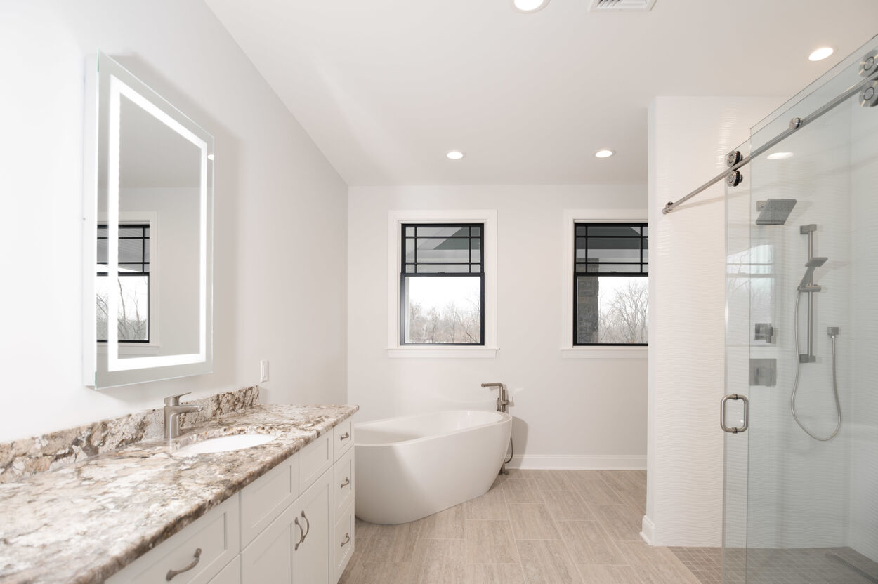 master bathroom with tub and walk in shower in custom home by gtg builders in central new jersey 