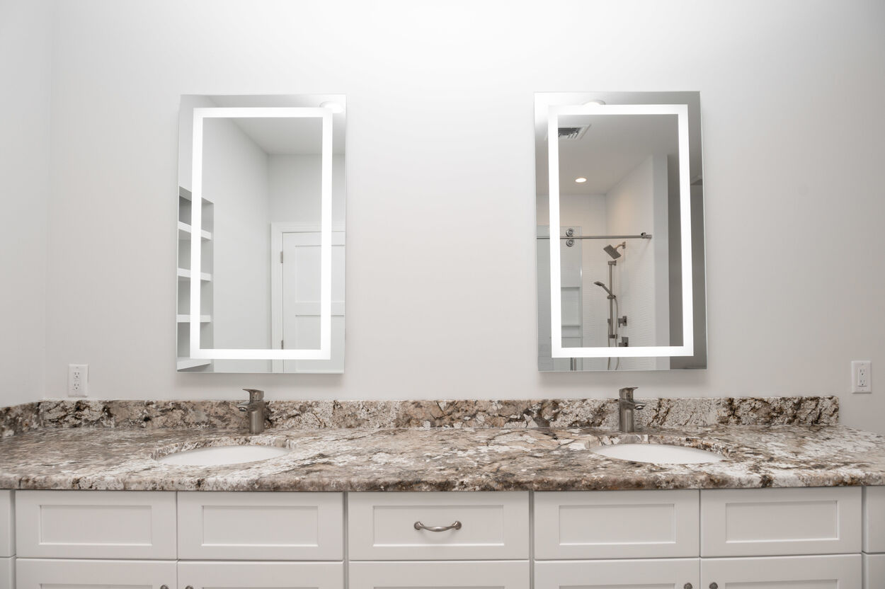 bathroom with double vanity and marble counterops in custom home by gtg builders in central new jersey