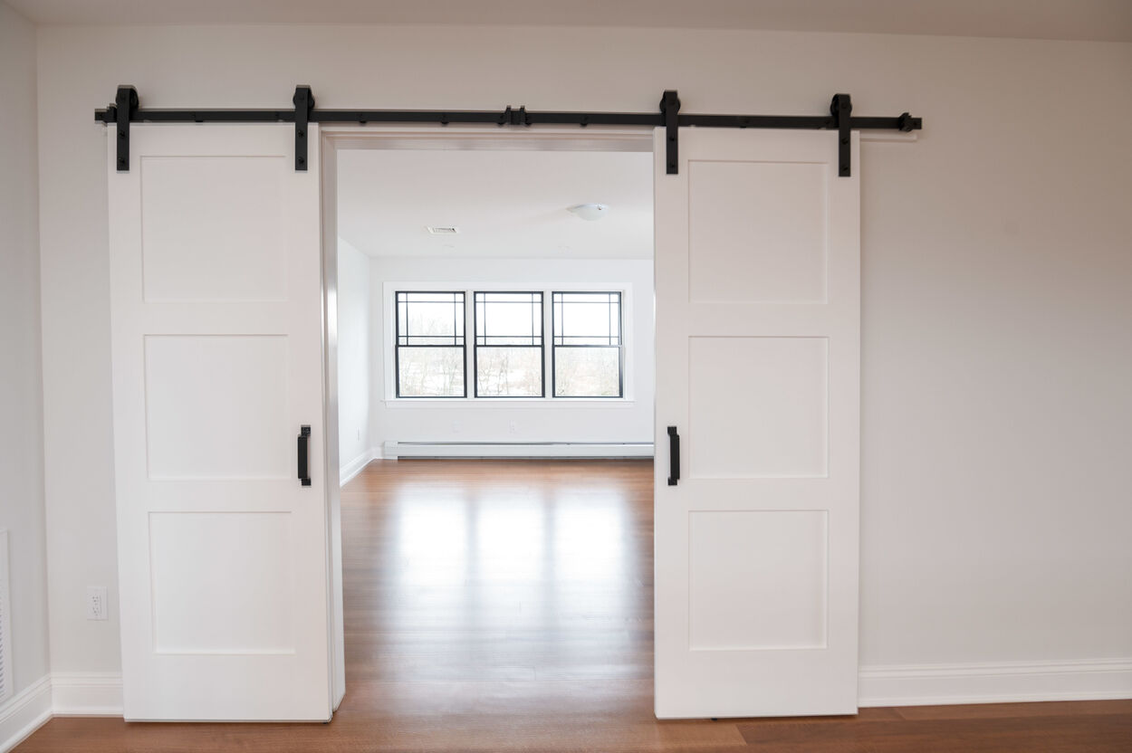 white barn doors in custom home by gtg builders in central new jersey