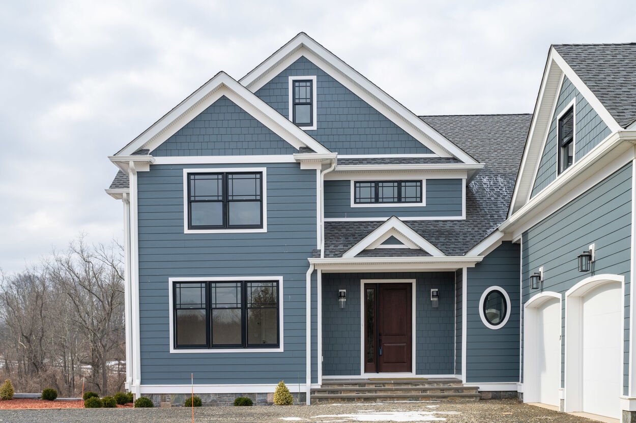 blue house exterior with two garages by gtg builders in new jersey