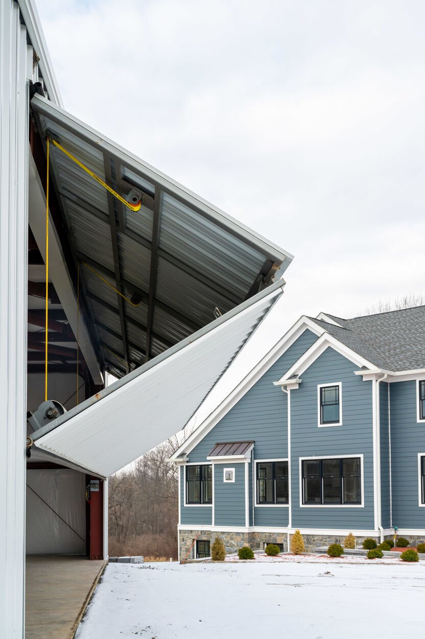 exterior blue home with hangar garage to the left by gtg builders in new jersey