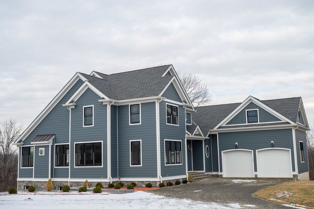 blue home exterior with 2 garages by gtg builders in new jersey