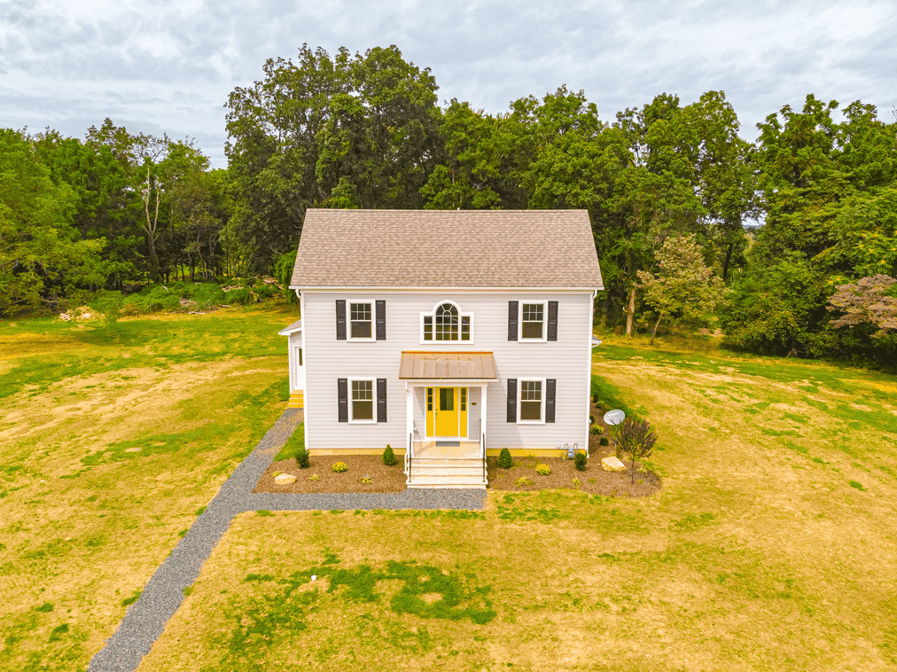 exterior of custom home with yellow door in central new jersey by gtg builders