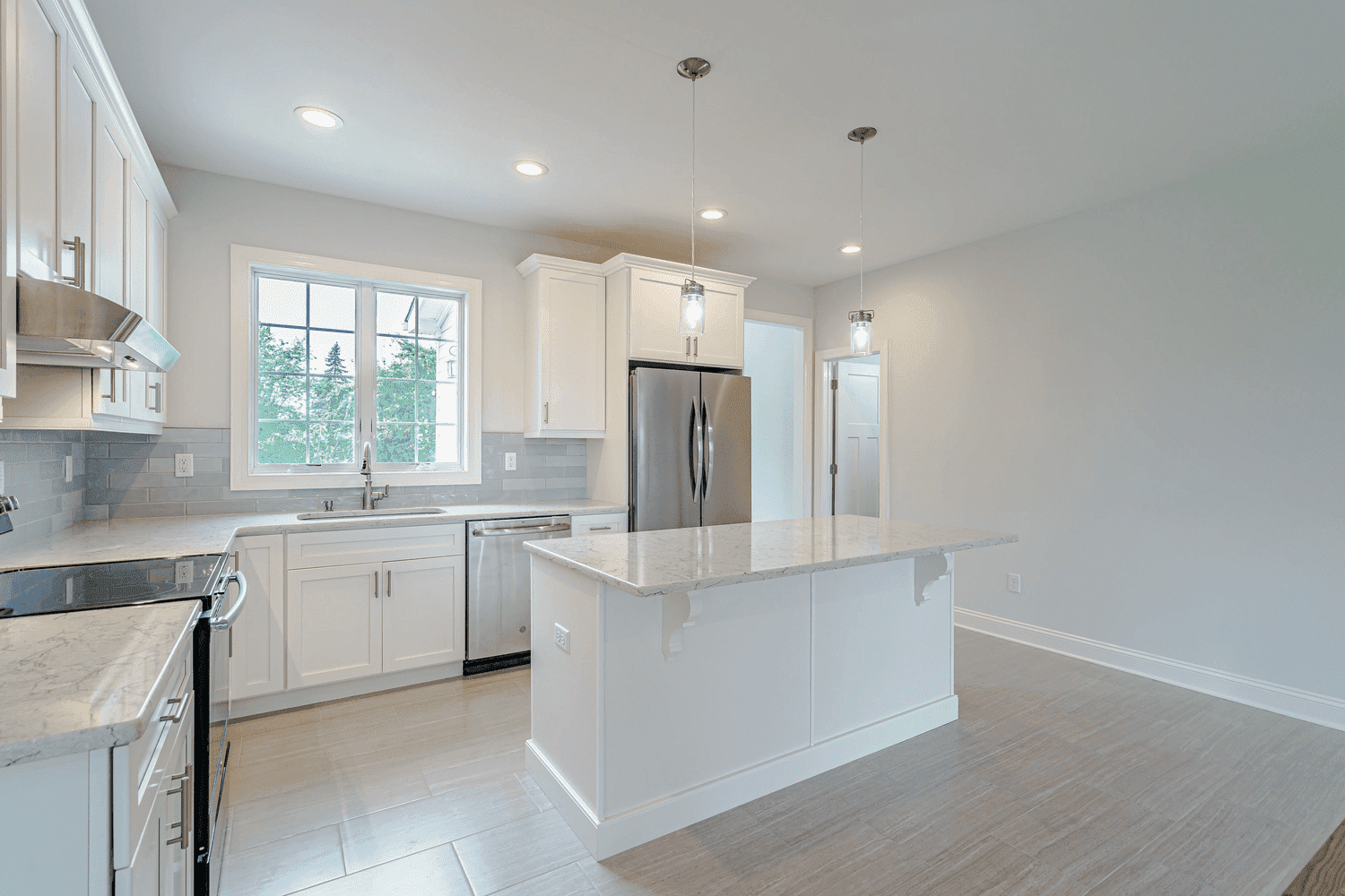 kitchen with island and white cabinets in custom home by gtg builders in central new jersey