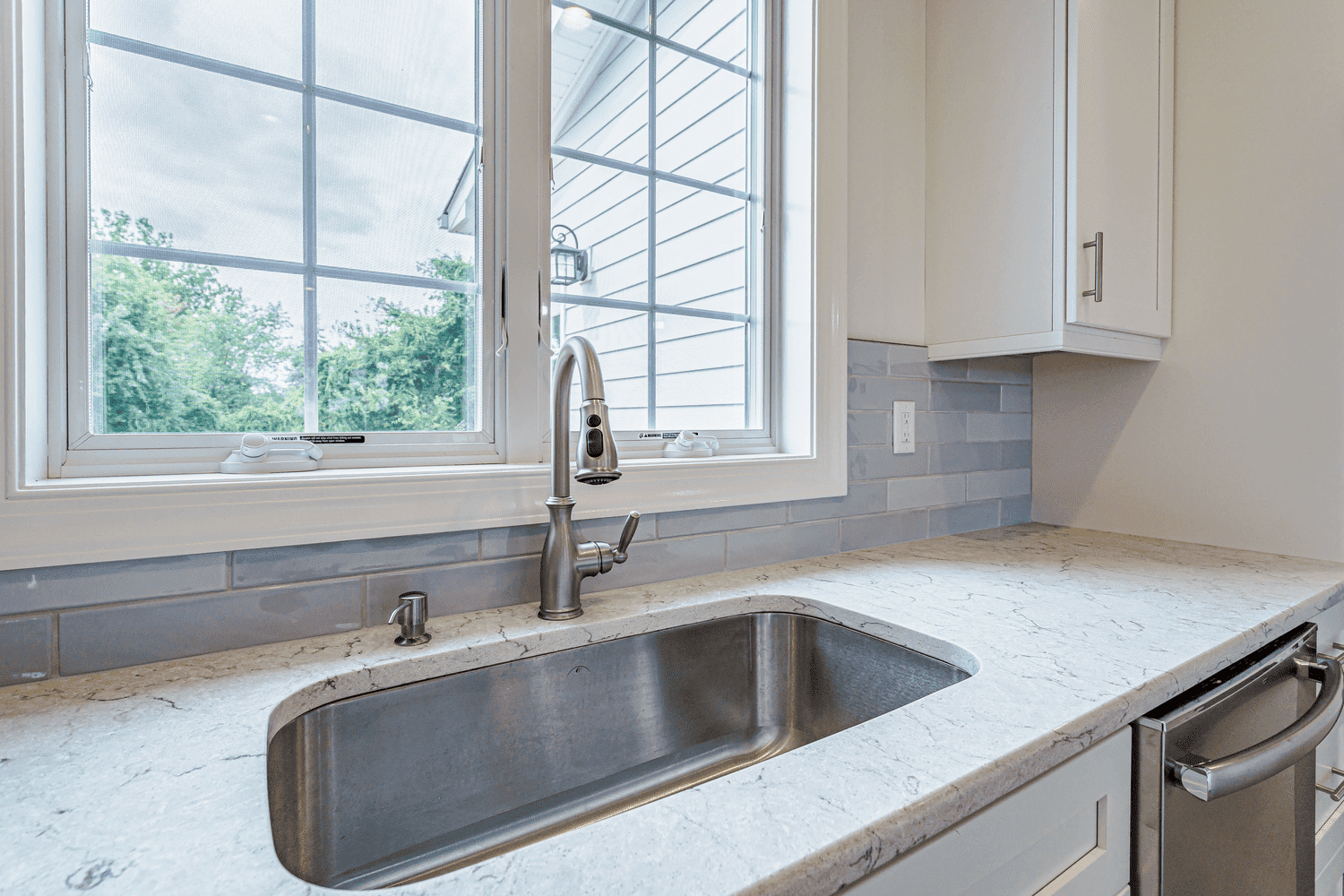 kitchen with sink and white cabinets in custom home by gtg builders in central new jersey