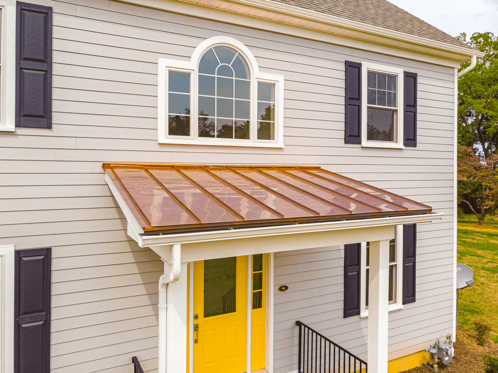 exterior of custom home with yellow door by gtg builders in central new jersey