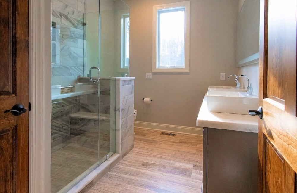 inside bathroom with double vanity and walk in shower in custom home by gtg builders in central new jersey