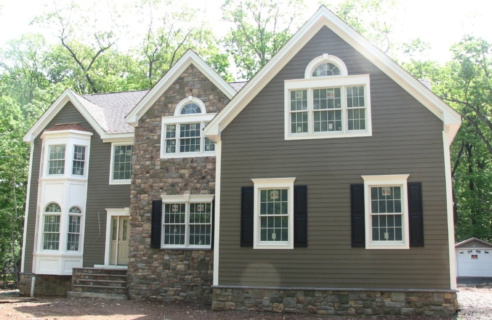 exterior of custom home with panel and stone by gtg builders in central new jersey