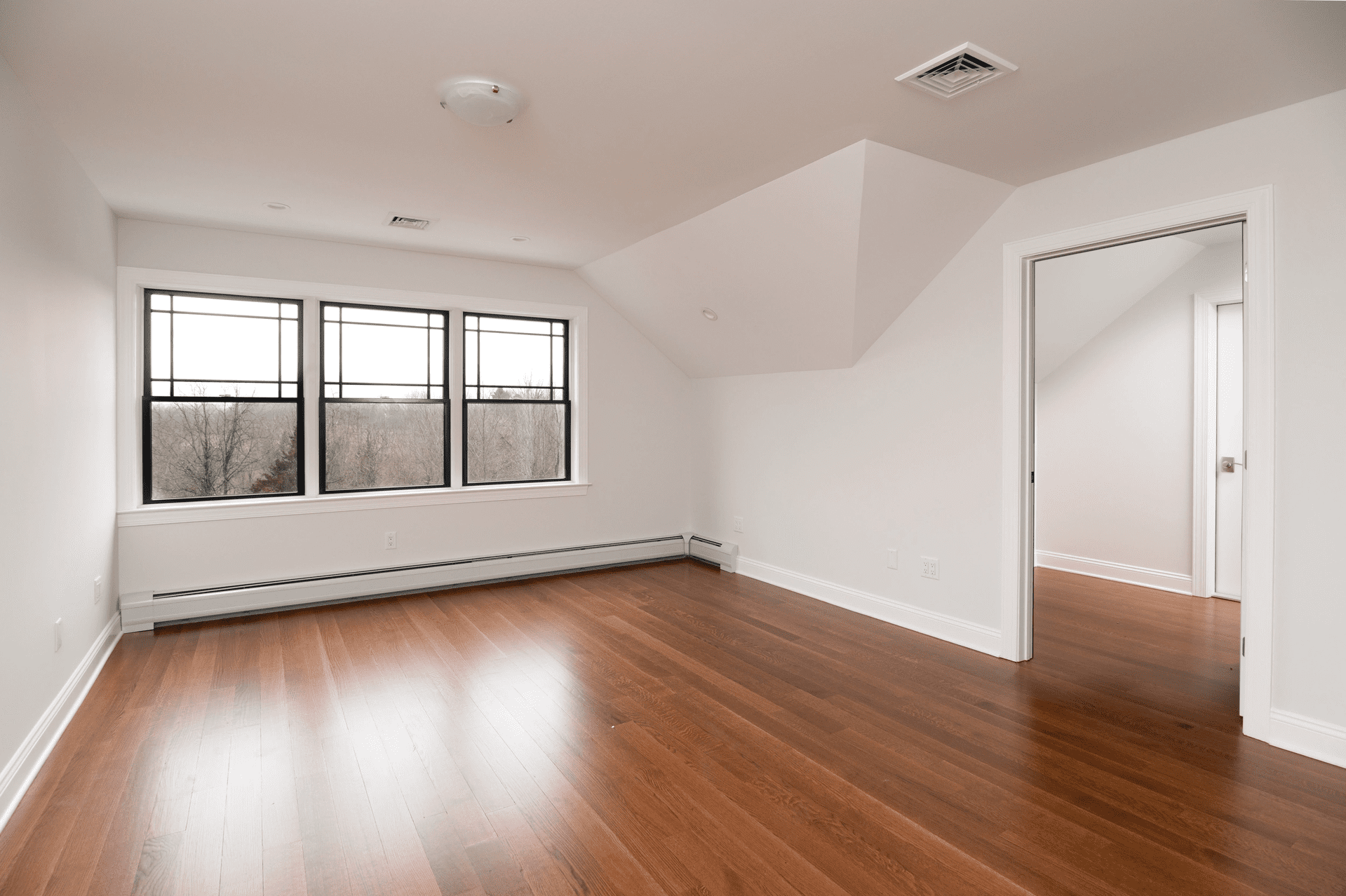 bedroom with hardwood floors in custom home by gtg builders in central new jersey