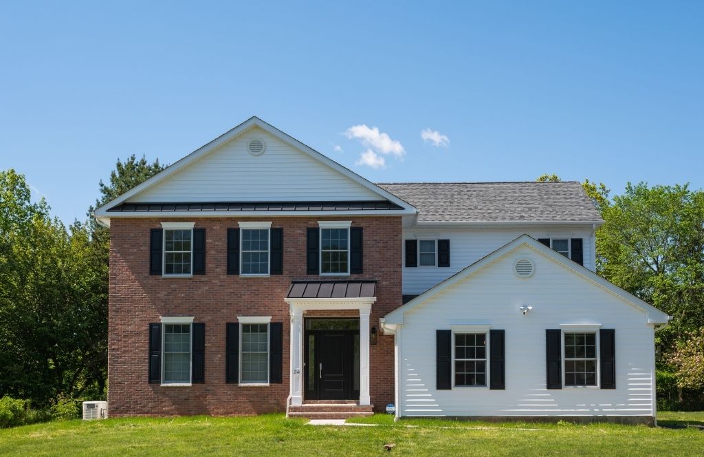 smithwold somerset nj red brick home in front of clear blue skies by gtg builders